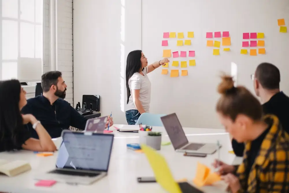 Marketing team mapping customer questions on sticky notes to plan an answer engine optimization strategy